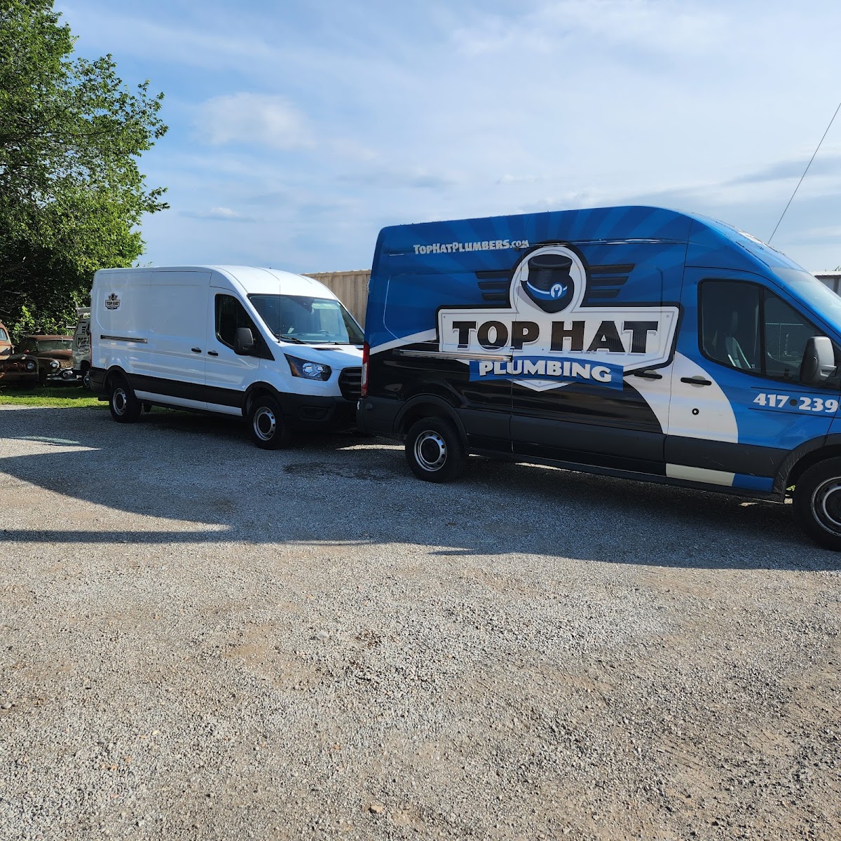 Top Hat Plumbing vans parked outside